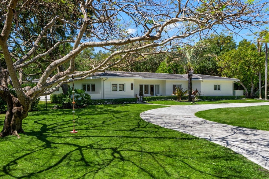 Situated on a sprawling 33,541 SF lot in the heart of Pinecrest, this beautifully renovated 4-bedroom, 4-bath residence offers a seamless blend of comfort, character, and indoor-outdoor living. Vaulted ceilings, coral rock detailing, and a fireplace bring warmth and timeless appeal to the interiors, while expansive living spaces open to covered terraces, a gazebo, and a covered outdoor dining area surrounded by lush landscaping and privacy. The primary suite features its own private terrace overlooking the grounds, creating a peaceful retreat within the home. Thoughtfully updated throughout, the property also includes a garage currently designed as a home gym with the flexibility to convert back into a 2-car garage. A rare opportunity to enjoy generous land, privacy, and a refined lifestyle in one of Pinecrest’s most sought-after neighborhoods.
