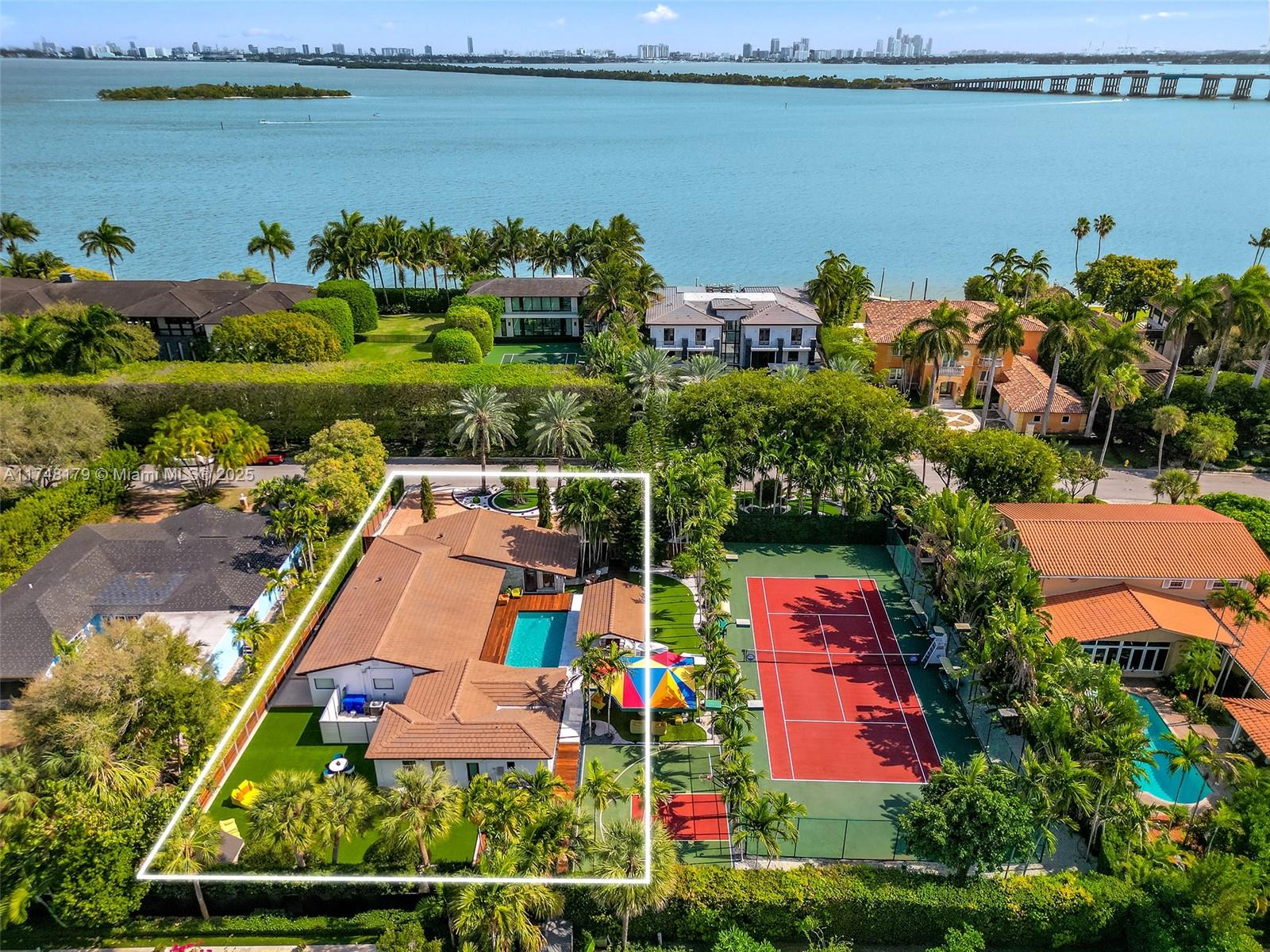 Located in Bay Point‘s most exclusive street Sabal Palm Rd, across the recently sold $85M home, and other trophy homes worth over $100M. This fully renovated, move-in ready 5-bedroom, 4-bathroom residence sits on a 13,346 sq.ft. lot and features a new roof, impact windows, and a modern kitchen. The guest quarters include an en-suite bedroom, morning bar and a spacious gym for extra comfort & convenience. For those seeking more space, this property can be combined with the adjacent 13,346 sqft lot which features a private tennis court (MLS A11748152) for $14,900,000. Bay Point is Miami’s only gated private community just 10 minutes from Miami Beach and MIA, near the Miami Design District, Midtown, and Wynwood. Close to the best private schools. Private financing available.