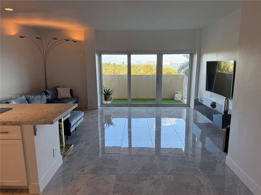 VIEWS VIEWS VIEWS!! Turnkey waterfront condo in the thriving MiMo District! To all foreign and out-of-state investors: this is the fastest growing area in Miami. This beautifully upgraded 1/1 will have you enjoy calming unobstructed water views from the living room, bedroom and balcony. It truly defines what Miami living is all about! Bright, spacious, and filled with welcoming energy, this unit features an open-concept kitchen and entrance, new modern flooring, motorized blinds in the living area, blackout shades in the bedroom, two California-style closets, and hurricane-impact windows. New refrigerator and dishwasher appliances recently installed. Enjoy a peaceful, residential feel while being steps away from a local waterfront park enclosed in a quiet community, Biscayne Blvd and the best of the Upper East Side. Nice neighborhood with fantastic restaurants and weekly farmer's market nearby! Resort-style amenities include a large waterfront Pool, 2 Saunas, Tennis court, Rec room, 24/7 Security and 1 designated parking spot. The A/C is included in the monthly maintenance fee (low electricity bill around $40). Recently remodeled lobby, saunas, and updated pool deck. The entire property is gated and secured 24/7. Priced below its last appraisal, do not miss this opportunity. Ready for move-in or investment rental. Well managed building, no Special Assessments. Easy to show - text listing agent.