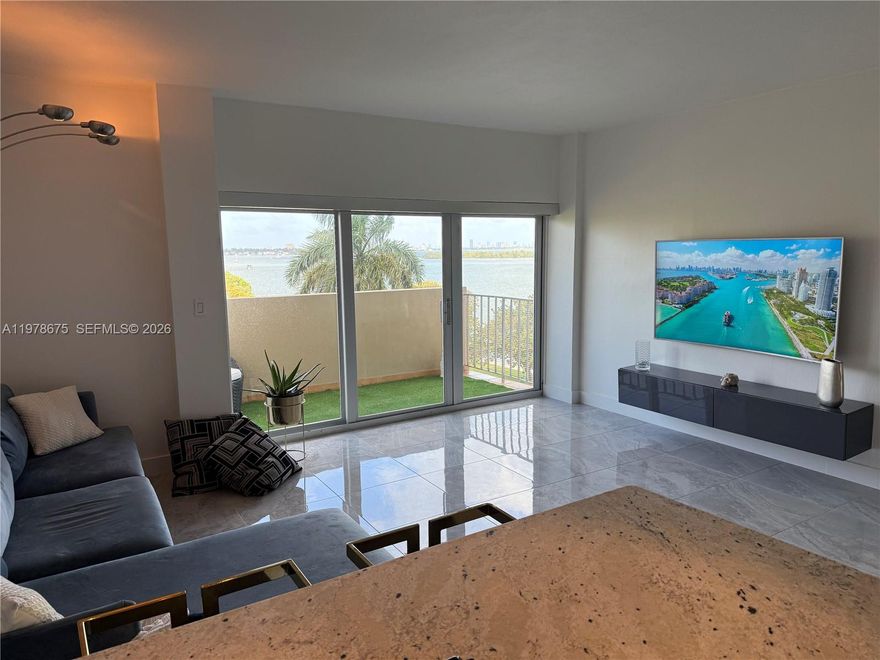 VIEWS VIEWS VIEWS!! Turnkey waterfront condo in the thriving MiMo District! Located on the bay-facing side of the building, this beautifully upgraded 1 bed /1 bath offers calming unobstructed water views from the living room, bedroom and balcony. Bright, spacious and freshly painted, this unit features an open-concept kitchen and entrance, new modern flooring, motorized blinds in the living area, blackout shades in the bedroom, two California-style closets and hurricane-impact windows. New refrigerator and dishwasher appliances recently installed. Resort-style amenities include a large waterfront Pool, 2 Saunas, Tennis court, Rec room, 24/7 Security and 1 designated parking spot. The A/C is included in the monthly maintenance fee (low FPL electricity bill). Recently remodeled lobby, saunas, and updated pool deck. The entire property is gated and secured 24/7. Priced below its last appraisal, do not miss this opportunity. To all foreign and out-of-state investors, this is the fastest growing area in Miami. Enjoy a peaceful, residential feel while being steps away from a local waterfront park enclosed in a quiet community and the best of the Upper East Side. Nice neighborhood with fantastic restaurants and weekly farmer's market nearby! Ready for move-in or investment rental. No Assessments. Easy to show - Text listing agent.