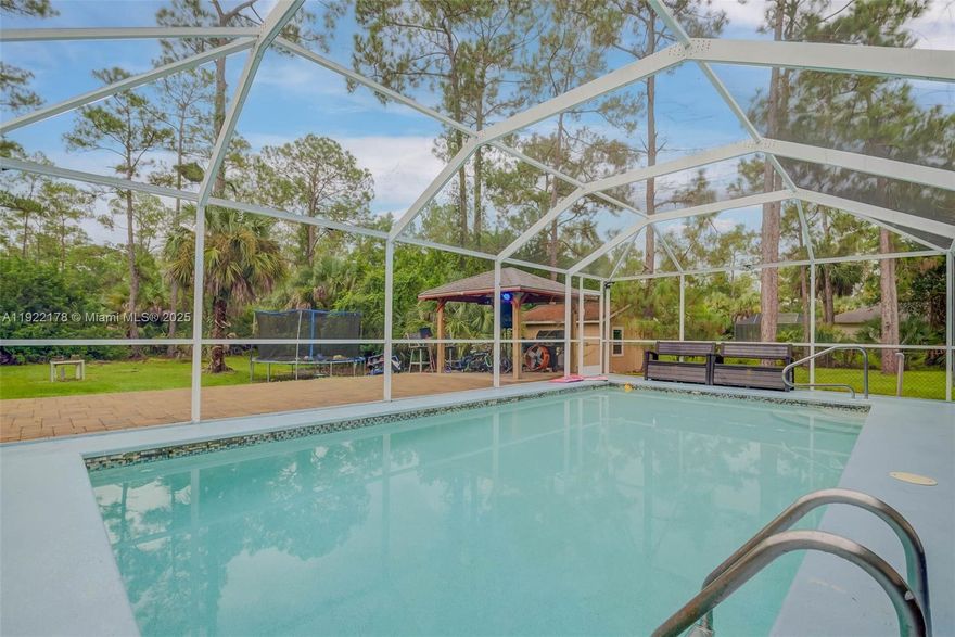 Brand New Roof before closing! This move-in ready 3-bed + Den, 2-bath home sits on over 1 acre and features a spectacular covered pool with a heater and paver deck. Enjoy unparalleled water quality with a BRAND-NEW, WHOLE-HOUSE Reverse Osmosis (R.O.) System, supported by new PVC plumbing joints, providing clean drinking water from every tap. Comfort is assured with a brand-new Trane AC (2024). The former garage has been converted and is currently used as living space in the home, offering great flexibility, and can be easily converted back to a garage or a man cave. The property also offers two laundry areas. Seller will professionally paint the entire interior at closing. Located just west of Wilson Blvd, this property offers acreage, luxury updates, and total peace of mind.