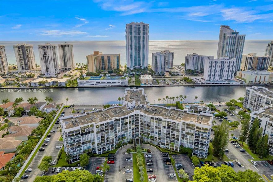 COME TO SEE IT NOW!   Relaxing water views from every room await at this upgraded and extra clean 1 Bed/2 Bath Condo. Spacious rooms with abundant natural light, floor-to-ceiling windows and extra closet space.   The OPEN KITCHEN features updated cabinetry and counter dining. Use the LARGE DEN as your dining room, living room extension or Home Office space.   Available FURNISHED OR UNFURNISHED.   Top waterfront location within the walking-friendly, GATED COMMUNITY of Three Islands with parks, playgrounds and world-class Beaches, Dining, Shopping, Golf & Int. Airports in close proximity.   RESORT-STYLE AMENITIES include waterfront Pool Deck, BBQ Area, Fitness Facilities, Tennis Courts and Club House.  24HR SECURITY/Front Desk. 1 assigned parking space.   CAN BE RENTED right after purchase.