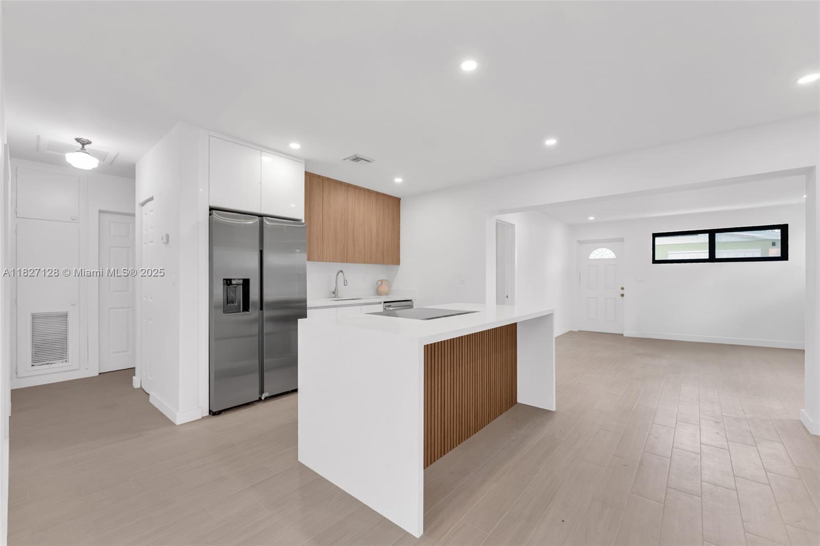 Located in a sought-after, family-friendly neighborhood, this beautifully remodeled 4-bedroom, 2-bath home offers the perfect blend of style, comfort, and flexibility. Thoughtfully upgraded with sleek porcelain tile flooring, modern bathrooms, updated lighting, a brand-new open-concept kitchen with a wet bar, impact windows, a new roof, and a tankless water heater—this home is truly move-in ready. The versatile split floor plan with separate entrances allows for two private living areas or one spacious layout, making it ideal for extended family or rental potential. The large backyard provides ample space for a boat, RV, or future pool. Conveniently located near top-rated schools, major highways, dining, and the airport, this home offers exceptional value and endless possibilities.