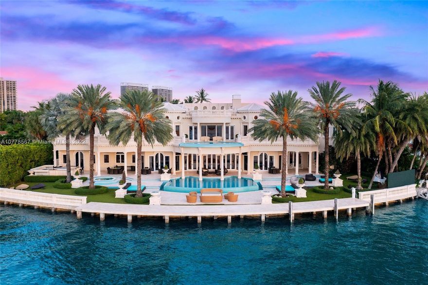 Absolutely unparalleled in finishes, appointments & furniture, this 12,879 SF palatial estate is designed like no other. Villa Magnolia sits upon 221 ft of wide waterfront with nw exposure, offering a front-row seat to dazzling sunsets. Private gates open to reveal a majestic Neoclassical home towering above verdant foliage. Enter into a rotunda foyer w/ a soaring 40-foot ceiling, curved marble & a striking two-sided staircase w/ white gold leaf bannisters. Unique features include hand-crafted stone throughout, European paint finishes, 15-foot coffered ceilings, 2-infinity edge pools, one just off the principal suite, 3rd level rooftop entertaining terrace, temperature-controlled 850-bottle wine room, gourmet kitchen w/ a built-in 750-gallon aquarium, movie theatre & glass elevator.