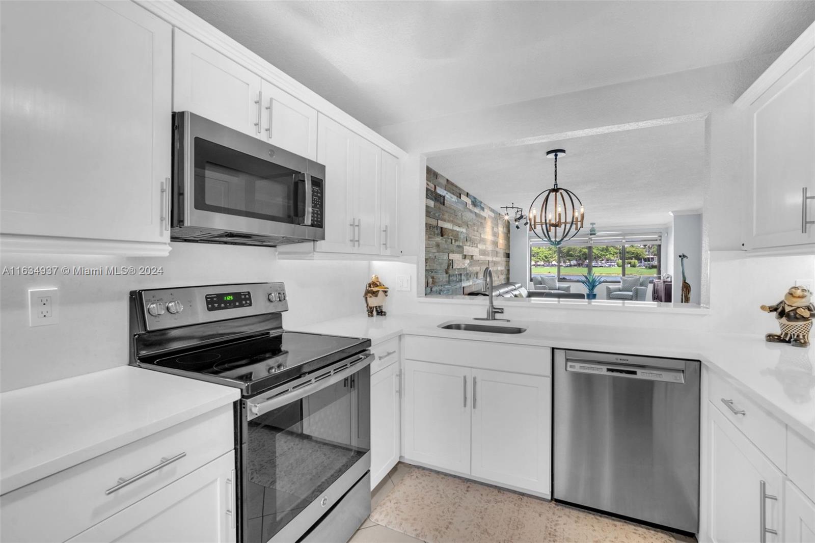 WOW!! This STUNNING fully updated 2 bedroom, 2 bathroom first floor Lakefront condo is the one you’ve been waiting for! Including: Impact windows & door, updated kitchen w/white quartz countertops & soft close cabinetry, stainless steel appliances, updated guest bathroom tub/shower, updated primary bathroom w/dual sinks & walk-in shower w/frameless glass sliding door & huge walk in closet, tile throughout, large laundry room in unit w/ample storage, decorated wood wall in living area & textured wall & ceilings throughout, newer lighting & fans, interior AC unit, crown molding, Zebra shades, large windows w/gorgeous lake & sunset views! 55+ gated community w/shuttle service, gym, pools, sauna, pickleball, theatre & cinema & so much more! Live where every day is a vacation!! Must see today!!
