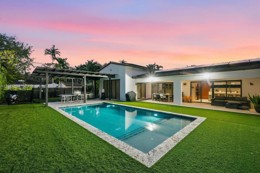 Introducing the Main Street Modern – A beautifully remodeled family home in the heart of Miami Shores, showcasing a striking white stone façade, and gated driveway with timeless curb appeal. Designed for today’s lifestyle, the home features a bright open layout and a spacious chef’s kitchen that flows effortlessly into the living and dining areas, perfect for both everyday living and entertaining.

Step outside to a private backyard retreat with a gorgeous pool and fully equipped outdoor kitchen, creating the ultimate setting for relaxing or hosting family and friends. Thoughtful upgrades include solar panels for energy efficiency and stylish finishes throughout.

Located on a main street in the Shores, this move-in ready home offers convenience, charm, and the perfect setting for family living just moments from parks, schools, and the vibrant Miami Shores Village.