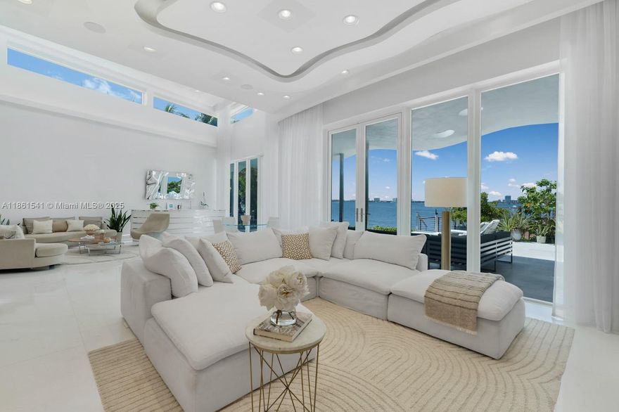 Step Inside With Me! This modern waterfront home on the gated island of Biscayne Point unveils sun-drenched interiors with unobstructed open-bay views. Thoughtfully designed, all social areas and guest spaces are arranged on a single level. Past the foyer, soaring double-height ceilings introduce bright living areas and a sleek specialty bar. The Mia Cucina gourmet kitchen highlights an oversized island with ample storage and boasts Wolf & Sub-Zero appliances. The spacious primary suite enjoys a private setting with a spa-inspired bath and sweeping water views. Outdoors, entertain effortlessly with a Summer Kitchen, infinity pool, hot tub and deep-water dock. Enhanced with advanced security, LED lighting & automation throughout, all just minutes from Bal Harbour, fine dining, & the beach.