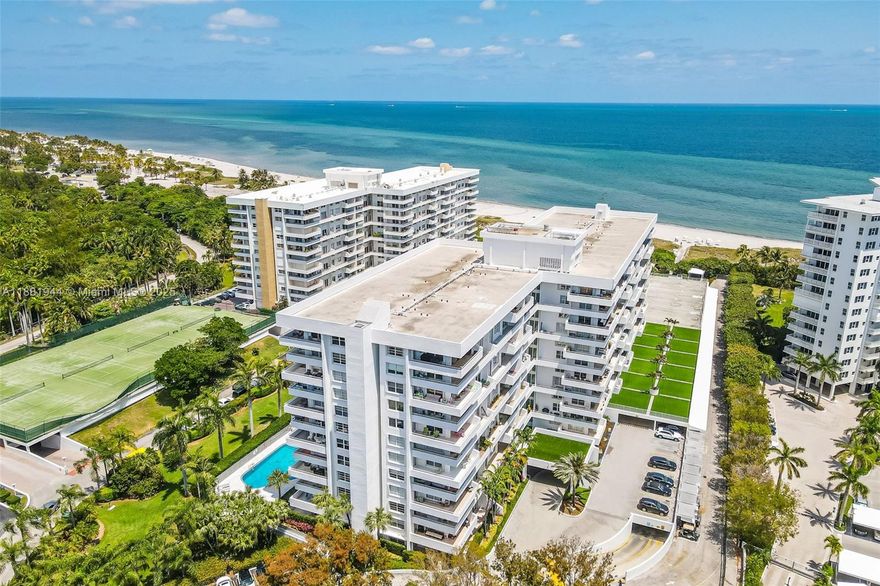 Rarely available corner unit at the Commodore Club West. This spacious and elegantly updated 3-bedroom, 2-bath residence spans 1,930 sq ft and offers breathtaking views of Crandon Park and spectacular sunset skies from a wraparound terrace. The functional layout includes a large master suite with a modern bathroom and generous closets, along with neutral travertine-style flooring throughout. The residence also boasts a hig-end Scavolini custom Italian kitchen. Enjoy the convenience of a rare in-unit laundry room equipped with high-end Miele washer and dryer. This residence includes one assigned, covered parking space. Residents of the Commodore Club enjoy direct beach access, a pool, tennis courts, and 24-hour security, an ideal island lifestyle in the heart of Key Biscayne.