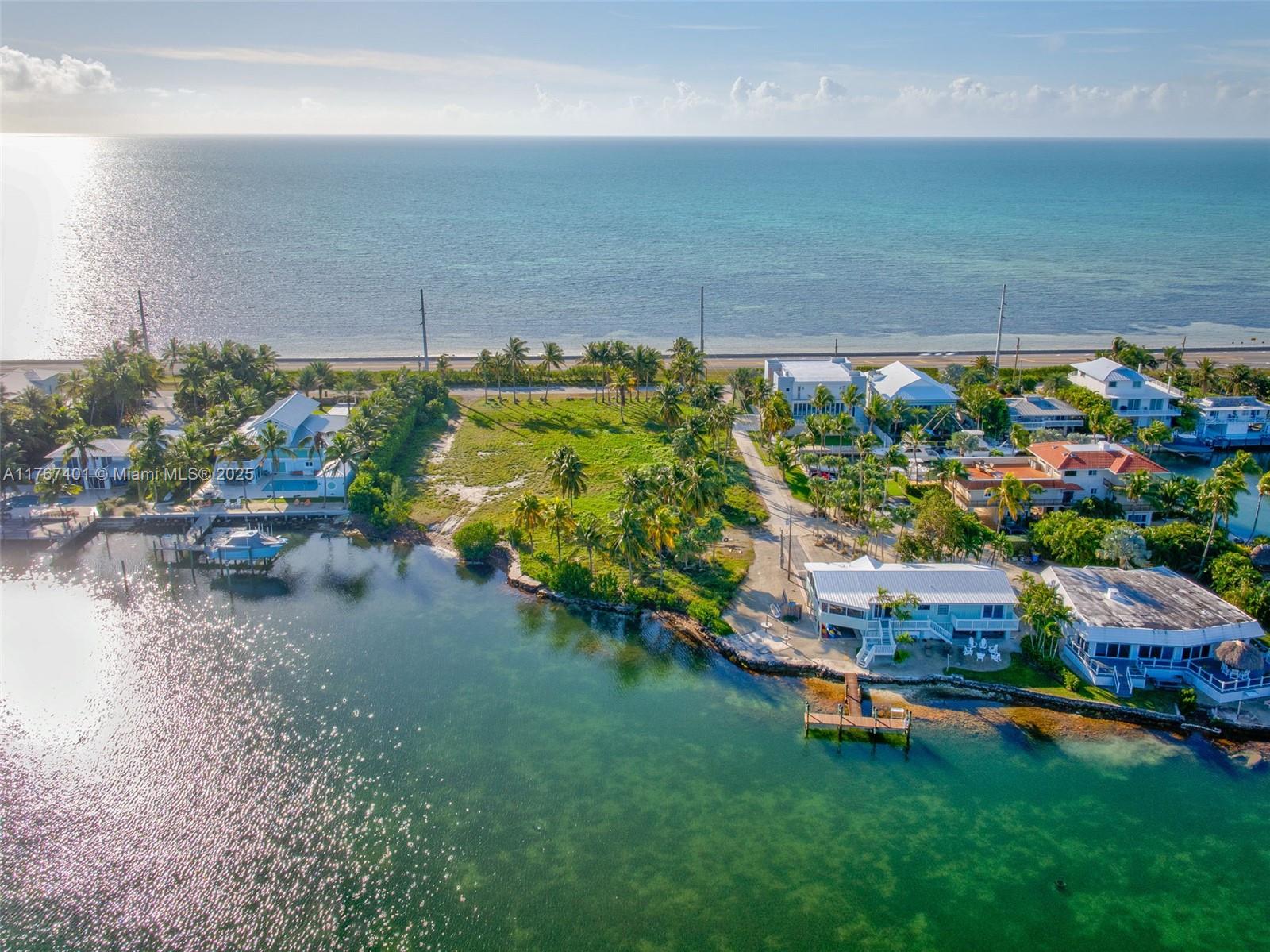 A unique opportunity to own a sprawling 32,450 sq. ft. vacant lot in one of Islamorada's most coveted locations. This exceptional lot offers open ocean views and stunning basin views, providing the perfect setting to create something truly special. With roughly 120 feet of water frontage, this property presents excellent dock opportunities, making it ideal for boating enthusiasts. With ample space to bring your vision to life, this lot allows you to design a private estate that perfectly suits your lifestyle. There are very few vacant lots of this size in Islamorada, making this a truly rare opportunity to own a piece of paradise!
