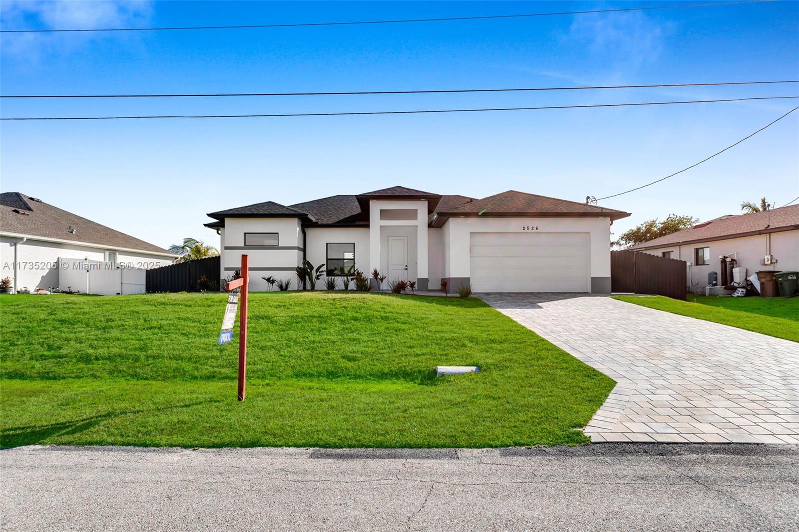NO FLOOD INSURANCE REQUIRED! This brand-new screened pool home is in one of Cape Coral’s fastest-growing areas! Offering 1,651 sq. ft., it features ceiling-height cabinets, Calacatta quartz, and 24"x48" polished tile flooring. Enjoy 9'4" tray ceilings, 8' doors, and impact windows & doors. The screened pool deck with LED lighting, brick paver driveway, and covered patio make outdoor living effortless. The master suite includes dual walk-in closets, a glass-enclosed shower, soaking tub, and dual vanities. Fully irrigated Floratam grass, 6' dark bronze aluminum fence, and 5' gates. Minutes from Burnt Store boat ramp, Pine Island Rd, and Coral Grove Town Center. Prime location—must see!