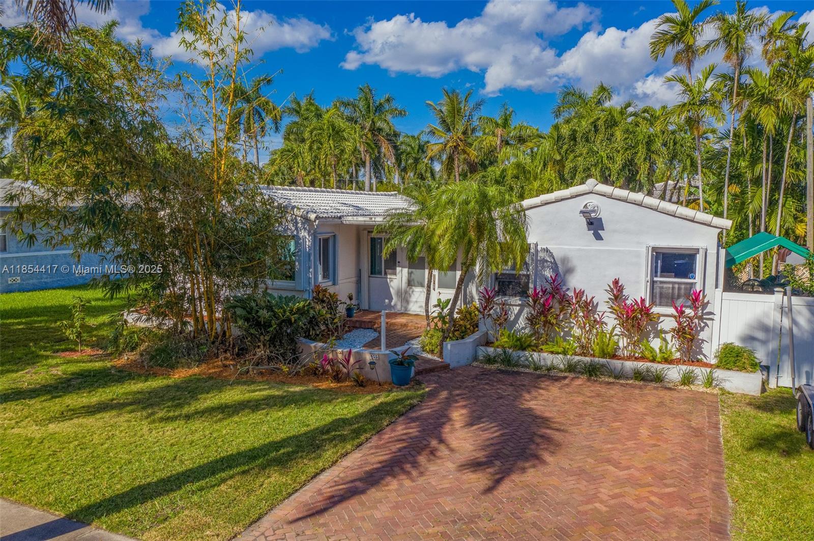 Short distance to the beach! 2015 fully renovated beautiful house with large heated salt water pool, spa,15.54 kw solar system (new, not on photos). Tropical backyard with roofed patio. Premium vinyl floors, tiles in bathrooms, Kitchen features quartz countertops, stainless steel appliances. LED lighting throughout the house and tankless water heater. New PVC sewer piping (2022), new flat roof (2023), all windows are impact windows and/or have hurricane shutters.