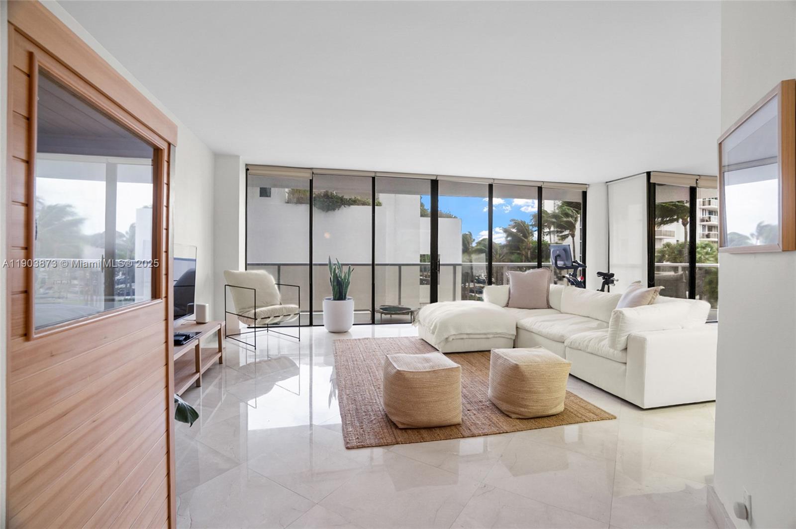 Beautifully remodeled 2/2 corner unit in the prestigious Hamptons West Condo. This home has 2 balconies & features a modern look with gorgeous marble floors. Updated Bathrooms as well as an updated kitchen with wood cabinets, granite counters, and stainless steel appliances. There is a Washer/Dryer inside the unit. This building is true luxury living! 2 pools, private gourmet restaurant & movie theatre, new state of the art fitness center/spa, tennis, racquetball, coffee shop, party rooms & kids room all on site!