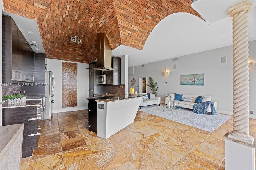 Experience penthouse living with breathtaking golf and city panoramas from a 50-ft balcony. This 2-bed, 2-bath residence spans 1,557 sq ft and blends architectural drama with modern sophistication. The featured vaulted brick ceiling and natural stone floors create a European-inspired ambiance, complemented by a remodeled kitchen with sleek cabinetry, granite counters, and mosaic accents. Spa-style baths showcase designer tile work and custom finishes, while motorized blinds add comfort and convenience. An assigned storage room on the same floor provides useful utility. The Consulate, a full-service tower within The Lands of the President, offers 24-hr security, pool and spa, fitness center, tennis, social room, and more. One assigned covered parking spot and plenty of guest spaces.