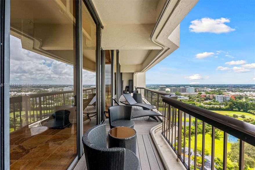 Experience penthouse living with breathtaking golf and city panoramas from a 50-ft balcony. This 2-bed, 2-bath residence spans 1,557 sq ft and blends architectural drama with modern sophistication. The featured vaulted brick ceiling and natural stone floors create a European-inspired ambiance, complemented by a remodeled kitchen with sleek cabinetry, granite counters, and mosaic accents. Spa-style baths showcase designer tile work and custom finishes, while motorized blinds add comfort and convenience. An assigned storage room on the same floor provides useful utility. The Consulate, a full-service tower within The Lands of the President, offers 24-hr security, pool and spa, fitness center, tennis, social room, and more. One assigned covered parking spot and plenty of guest spaces.