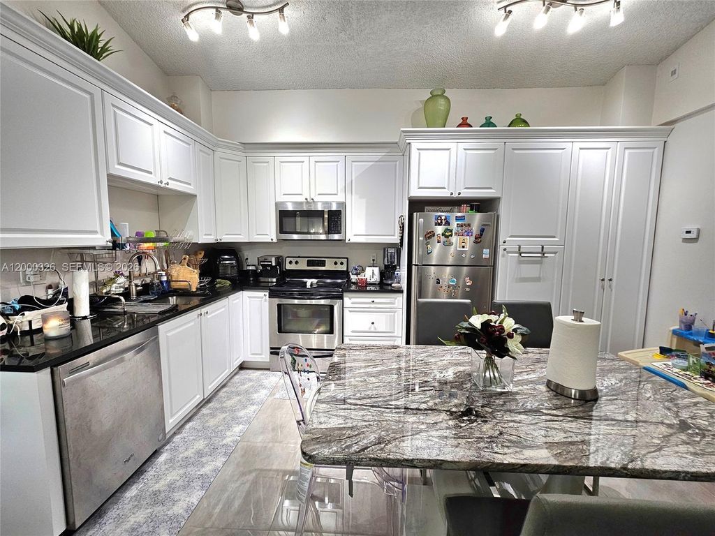 Photo of 841 Lyons Rd #24205, Coconut Creek, FL 33063 (MLS # A12000326)