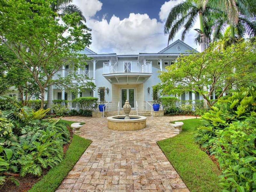 Beautiful custom built Key West style home situated on large, lusciously landscaped lot. Great floorplan with open spaces, high ceilings and impact windows throughout. Gourmet open kitchen, family room with bar area and separate office/guest house. Exquis ite finishes include handmade crown moldings, custom shutters, elevator and over 3,000 sq ft of covered wrap around balconies. Beautiful grounds w/ a summer kitchen, fountains, and covered terraces.