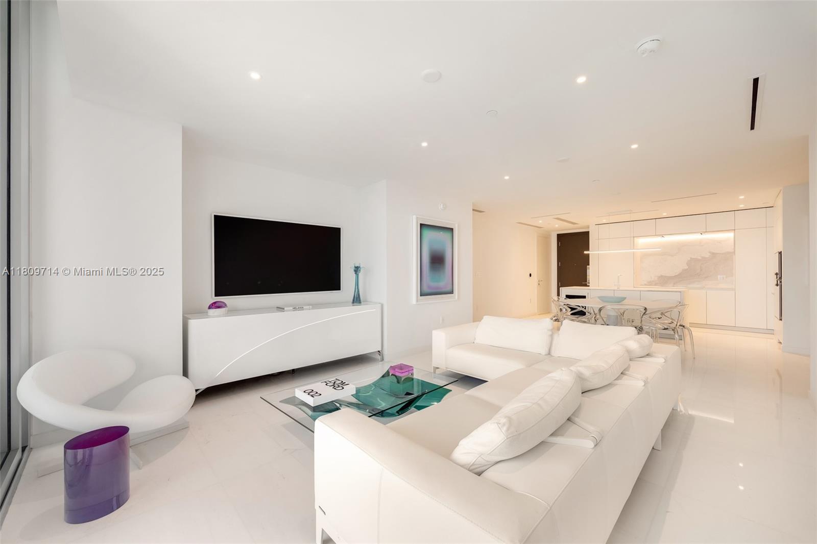 Rising 52 stories above Miami, this move-in ready 1,699 SF residence redefines luxury with panoramic views of the ocean, bay, and skyline. With soaring 10-foot ceilings and expansive floor-to-ceiling windows, it is the highest-floor 2-bedroom + den residence in the building, offering exceptional light and spacious elegance. The fully customized chef’s kitchen features Calacatta Cozzano marble, Gaggenau appliances, and Franke fixtures. Additional highlights include Kohler Veil smart toilets, custom closets, recessed lighting throughout, and motorized Bandalux shades. Residents enjoy over 42,000 SF of resort-style amenities: a 55th-floor infinity pool, private cinema, spa, two-story fitness center, golf simulator, and helipad. A true showcase of sophistication and style.