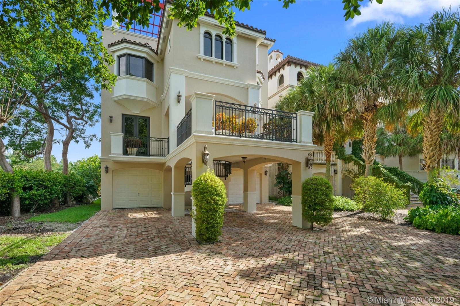 Enjoy the remarkable water & treetop views from this fantastic three story, 4 bdrm/ 4.5 bath home in the gated community of Paradise Point. A short boat ride from slip #5 (included in the purchase) to Biscayne Bay. Beautiful millwork, crown molding, impact windows/doors, soaring ceilings, expansive terraces, elevator. On the main floor, formal living/dining, chefs kitchen w/ breakfast area. Family rm w/ wet bar. On the second floor, the master suite beckons, spacious bath w/ separate tub & shower & gorgeous views to match plus 2 guest bdrms. The top floor opens to additional family rm. bar and kitchenette, guest bdrm, two patios w/ jacuzzi perfect for gatherings. 2 car garage, gym, covered patio on ground flr. Community amenities, pool, tennis, private beach.