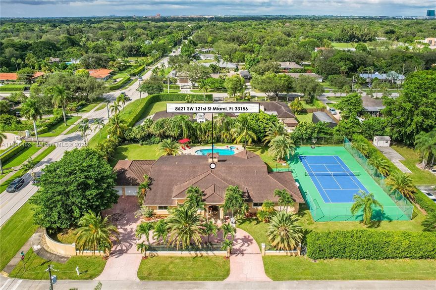 Look no further this home is priced to sell! One of the best priced per sqft. homes in the market! Located within minutes of Pinecrest, this home is situated on a corner on a true builders’ acre lot, completely gated. Boasting 5500 + sqft with 12 ft ceilings and redone in 2007. Spacious 7br/7.5 bath with a split plan. The master bedroom features an additional room (sitting area), and large bathroom. Featuring vaulted wood beam ceilings, working fireplace, chef style kitchen with stainless steel appliances, 2-car garage, large covered terrace and pool area, landscaping, and tennis court which can be easily converted to a basketball court. Impact windows throughout with accordion shutters, and security system, facing a no thru street.