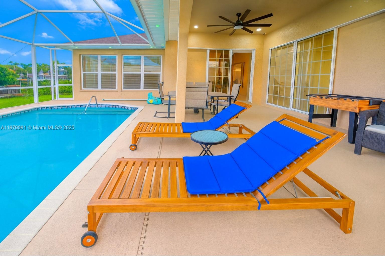 SW Cape Gulf Access pool home with new roof (2023), assumable solar panels (2024) for low bills, high-efficiency A/C with UV cell (2024), and renovated saltwater heated pool. European-style kitchen with waterfall island, induction cooktop with pop-up vent, wall oven, cappuccino maker, drawer microwave, 48” fridge/freezer, and wine cabinet. Family room with granite feature wall, fireplace, and TV opens to lanai with wood slat wall. Primary suite with frameless glass shower, dual rain heads, body jets, towel warmer, floating vanities, smart mirror, Bluetooth speakers, and custom walk-in closet. Two guest bedrooms with full baths. Heated pool, private dock, Gulf access in 30 mins. Currently rented on Airbnb for $4,000/month transferable until March 2026, or buy as a family home.