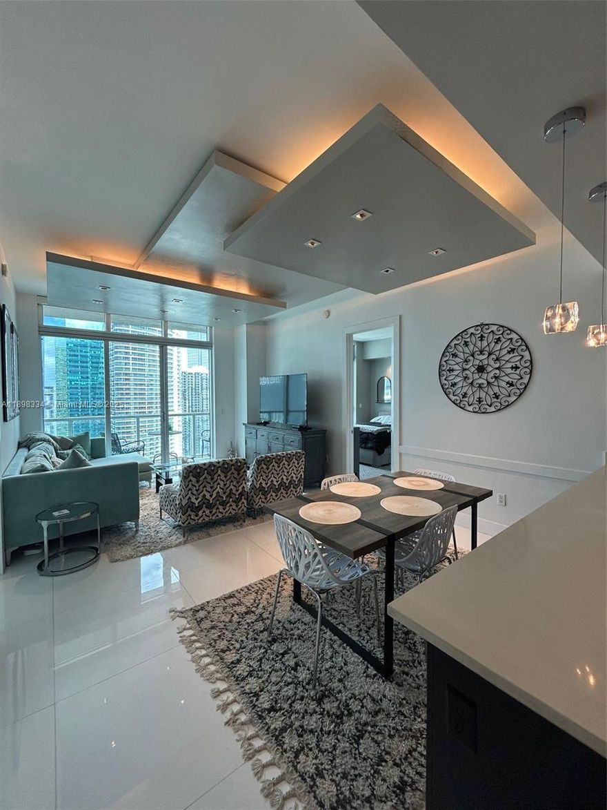 Experience luxury living in this fully furnished 2BR/2BA residence on the 41st floor of the prestigious 500 Brickell Condominium (East Building). Enjoy spectacular water and city views from floor-to-ceiling windows in all bedrooms and through the spacious open living area. Both bedrooms feature en-suite bathrooms for added privacy and comfort. Modern kitchen with stainless steel appliances, in-unit washer/dryer, and one assigned parking space. Building offers resort-style amenities including rooftop pool, fitness center, spa, clubroom, and 24-hour concierge — all steps from Brickell City Centre and top dining.