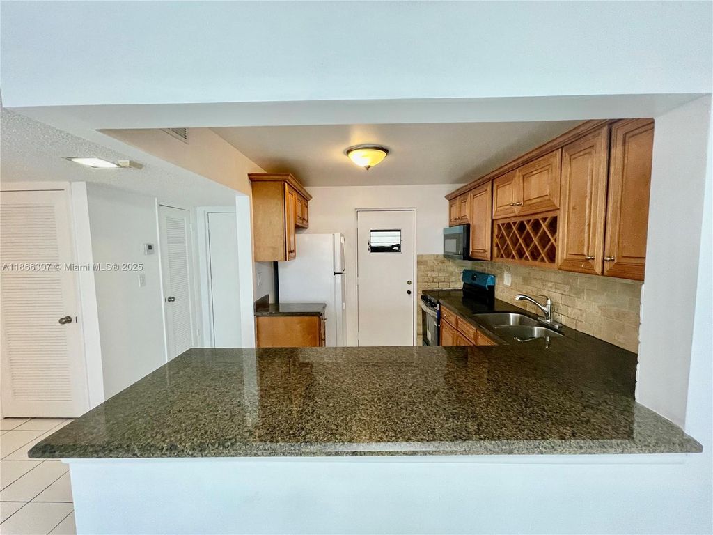 Photo of 2320 S Cypress Bend Dr #305, Pompano Beach, FL 33069 (MLS # A11866307)