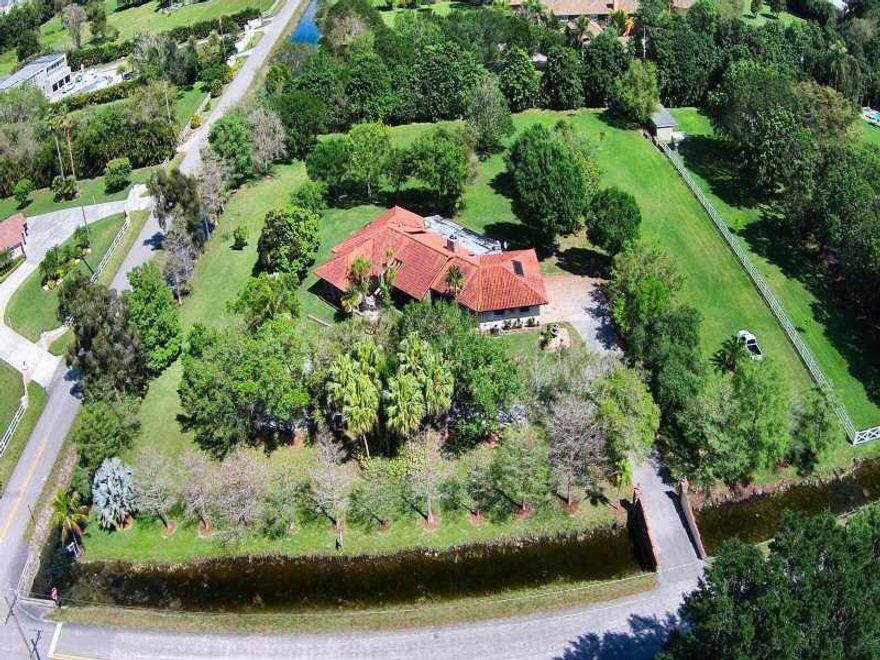 SOUTHWEST RANCHES GREAT POTENTIAL CORNER PROPERTY OFFERS 2 ACRES OF LAND WITH A 3000 SW FT HOUSE, LAY OUT FLOOR PLAN FEATURES A LARGE 3/2,5 WITH THE OPTION OF EXPAND, REMODEL OR SIMPLY UPGRADE, LARGE SPACIOUS FLOOR PLAN LAY OUT, HOUSE WAS BUILTED ON LAND  FILLED IN RAISING GROUND LEVEL, CIRCULAR DRIVEWAY ENTRANCE, LARGE EXTENSIVE COVERED PATIO, LOT IS PARTIALLY SURROUNDED BY WATER CANAL, LOTS OF TREES, GREEN AND LOTS OF POTENTIAL TO TURN THIS GREAT PROPERTY INTO YOUR DREAM RANCH HOME. CALL TODAY. THANK YOU