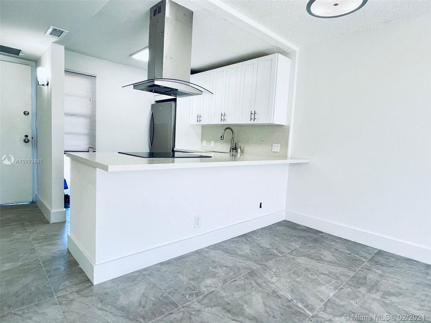 Absolutely stunning, fully renovated 1 Bedroom 1.5 Bath unit in Ensenada Condo. Situated in the heart of Aventura on famed N Country Club Drive, the location of this unit couldn't be better. Owner has spared no expense on updates for this unit. Brand new Kitchen with quartz counters, high-end stainless appliances, imported porcelain flooring, LED lighting, remodeled baths.. Literally everything was redone. Unit features an open floor-plan layout which makes it feel larger then the square footage suggests. The bedroom is large and features 2 full sized, fully built out walk-in closets and a vanity/powder room separated from the shower and bathroom. The over-sized balcony overlooks  Country Club Dr and is fully screened. Entire unit freshly painted and has Full accordion hurricane shutters