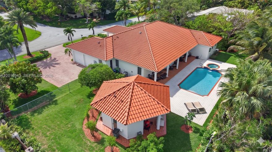 Located on a quiet street near some of the area’s top-rated public and private schools, this beautiful one-story pool home sits on an oversized 19,800 SF lot with expansive green space and offers the perfect blend of comfortable indoor living and exceptional outdoor entertaining. Soaring cathedral ceilings enhance the spacious living areas, while the pool and jacuzzi, along with a covered outdoor kitchen gazebo featuring a fully equipped BBQ area and additional half bath, create a true backyard retreat. The spacious kitchen includes stainless steel appliances, granite countertops, and an open breakfast area overlooking the pool. Additional features include impact windows, two tankless water heaters, two newer A/C's, a full laundry room, 2-car garage, circular driveway, and a fully fenced yard for added privacy and security. Conveniently located near Deering Estate, Deering Bay Yacht & Country Club, and Black Point Park and Marina.