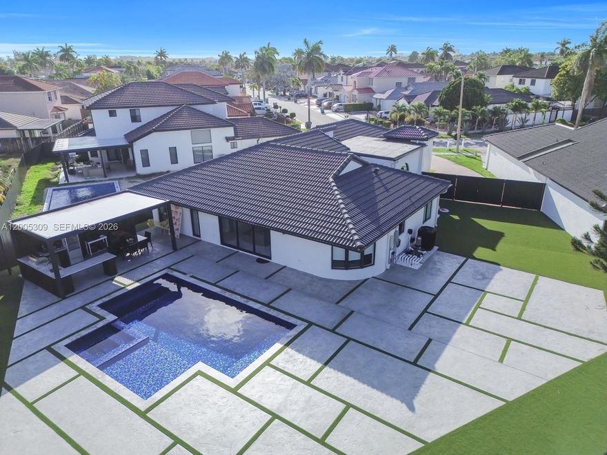 Exceptional 6-bedroom, 4-bathroom home offering more living space than the tax roll, plus an office/den, storage room, and 1-car garage, all situated on an oversized 10,400+ sq ft lot. Completely redone in 2024, the home features large porcelain tile flooring, a stunning kitchen with designer wood cabinetry, a quartz island, and premium appliances. All four bathrooms have been beautifully renovated with high-end finishes. The home also features recessed LED lighting, two 3.5-ton new central AC units, full impact windows and doors, and a new metal fence with a back entrance door, great for guest access during parties. The backyard is an entertainer's dream. Step outside to a newly finished heated pool, a massive concrete patio, and a designer outdoor retreat boasting a fully equipped chef’s summer kitchen with marble counters, slat-wall detailing, and an insulated all-weather roof. This is an unbeatable location with easy highway access for effortless commuting - just minutes from Miami International Airport and South Beach, and close to Dolphin Mall and Doral.