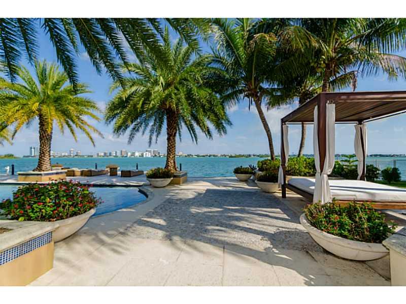 Grand estate with 150 FT on open bay! This waterfront estate sits on 22,500 SF lot w/ 9,000 SF (per appraisal) of interior luxury. Features include: entry w/ double volume ceilings; huge gourmet kitchen w/ gas stove; family room w/ wet bar; movie theater; billiard room; gym; & wine storage. There is a huge master suite with sitting area & walk-in closet. The outdoors is a one of a kind paradise w/ heated pool, summer kitchen, wood burning pizza oven, guest house, children playground, dock & boat lift.