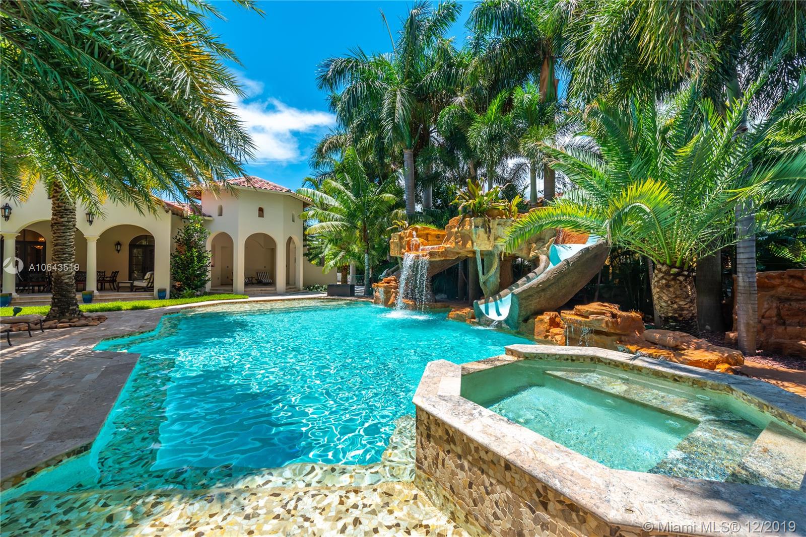 MOTIVATED SELLER!!! Located on prestigious Pinetree Dr this resort-style oasis is situated on a walled 30,000SF corner lot. This impressive home exudes elegance w/ 12ft vaulted ceilings & superior attention to detail. The main residence spans across one level of 4,746SF interior space, 5bd, 5.5ba, office, formal living room, dining room & over 1,000SF of covered terraces. The exquisite eat-in gas kitchen features large marble island & opens up to the great room, separate breakfast area & laundry room. The covered patio & outdoor dining area lead to eye-catching 25x50 pool w/a custom waterfall grotto, slide & spa. Also on the vast grounds is a separate two-story guest house featuring 2bd, 2ba & private entrance w/gated parking for 4 cars. Custom impact windows throughout & 2-car garage