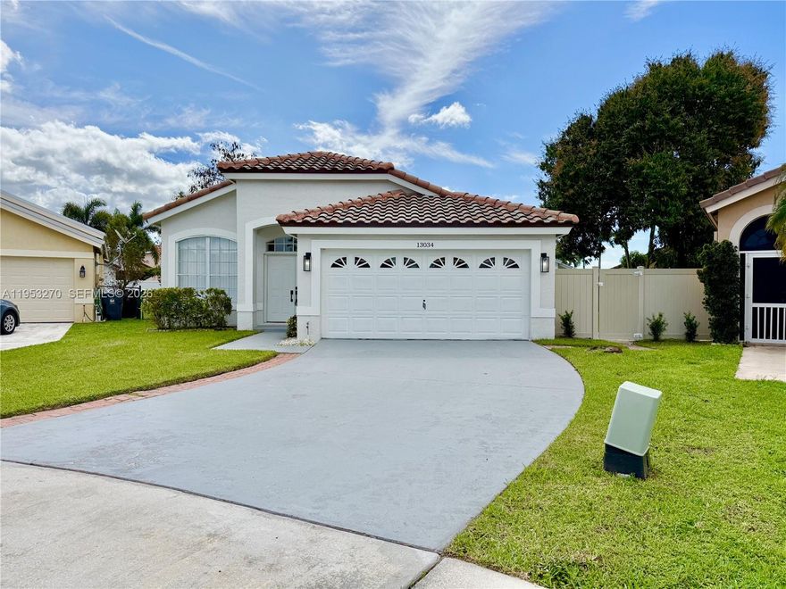 This beautifully updated single-family home is tucked away on a quiet Wellington cul-de-sac within an A-rated school district, featuring a 2023 roof, a two-car garage with a spacious driveway, an attic, and an interior and exterior recently painted. The open-concept interior shines with natural light and luxury waterproof vinyl flooring, highlighting a modern kitchen equipped with white cabinetry, a central island, a pantry, and a large Calacatta quartz countertop perfect for eating and entertaining. The primary suite offers a true retreat with a walk-in closet and an elegant bath featuring double vanities, a walk-in shower, and a floating tub, while the second bathroom includes a relaxing soaking tub. Step outside to a screened-in patio and a private, fenced backyard shaded by mature trees, offering plenty of room for a future pool. Located in a central area with low HOA fees, this move-in-ready gem perfectly balances style, comfort, and functionality.