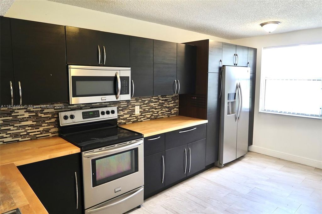 Photo of 8801 Wiles Rd #202, Coral Springs, FL 33067 (MLS # A11824461)