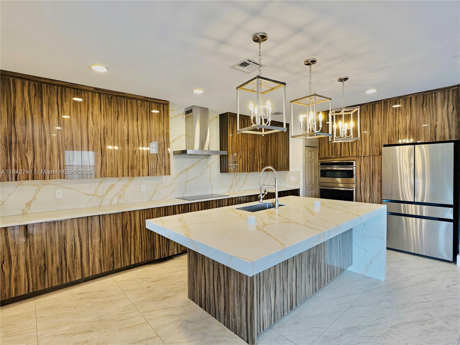 This is the one you don't want to miss! A Fully renovated 4 bedroom, 2.5 bathroom residence in the exclusive community of Olympia! 9083 Dupont boasts an array of high-end features, sitting on a massive 7,814sqft lot perfectly situated in front of a beautiful nature preserve. The home features 3,158 total sqft w/ a new Water Heater, Tesla EV charger & Generator! Step into a world of elegance w/ Custom high-gloss European cabinetry, GE Stainless Appliances, exquisite Gold Vein Calacatta Quartz Countertops, a 4-inch mitered edge island w/ built in wireless charging stations & Navona stone floors. Outside in your private fenced in backyard you will enjoy a functional Wet Bar and delicious Coconuts, Mangos, Avocados, Papaya, Bananas, Herbs and Limes!