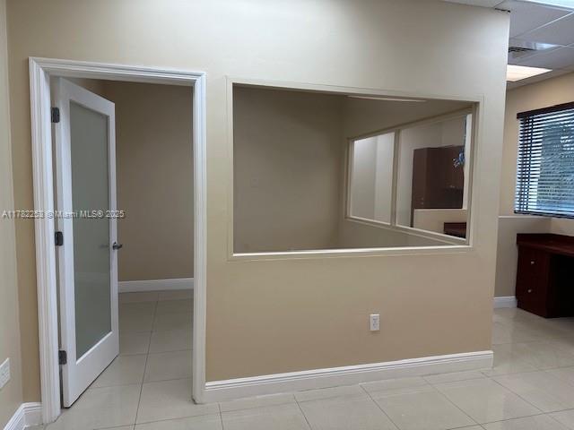 Second floor executive suite (approx. 477 sqft) with 1 private office, open area, tiled floors, and lots of windows. Rent includes A/C, electricity, and Wi-Fi. Common area bathrooms, lounges, and conference rooms on each floor. 24/7 access with card entry after hours and weekends.