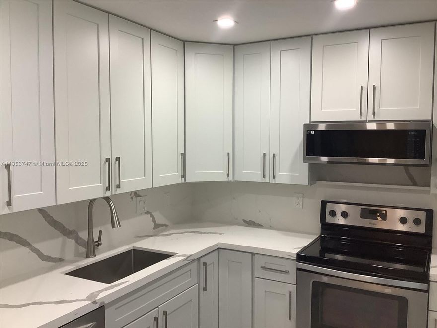 Make this beautifully updated 2-bedroom, 2-bath condo where style and functionality blend seamlessly your own. Located in the heart of Lauderdale Lakes, this residence offers a fresh, contemporary vibe with every detail thoughtfully curated. Crisp white countertops and cabinets create a clean, airy ambiance in the kitchen, perfectly complemented by sleek stainless steel appliances. A sophisticated mix of porcelain and ceramic tile flooring flows throughout the space, adding texture and durability with a designer touch. The master bathroom is a true retreat, featuring a smart toilet with bidet and heated seat. Both bedrooms offer generous space and natural light, making them perfect for restful nights or a stylish home office setup.