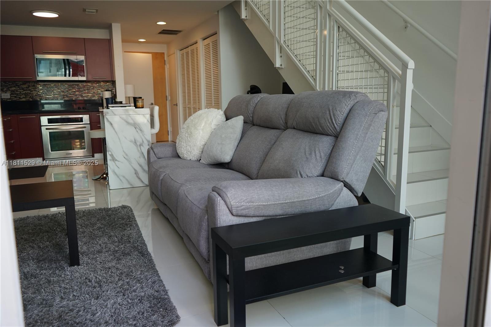 Very nice two-story loft; 1 Bedroom, 1 Full Bath upstairs 1/2 Bath downstairs with 18' floor to ceiling windows; Lounge in the tropical pool while your friends enjoy a massage at the spa or a drink at the wet bar. Building is located directly in front of BAYSIDE; Amenities include: 2 Pools, pool table, media room, conference room, Wi-Fi lounge, running track.