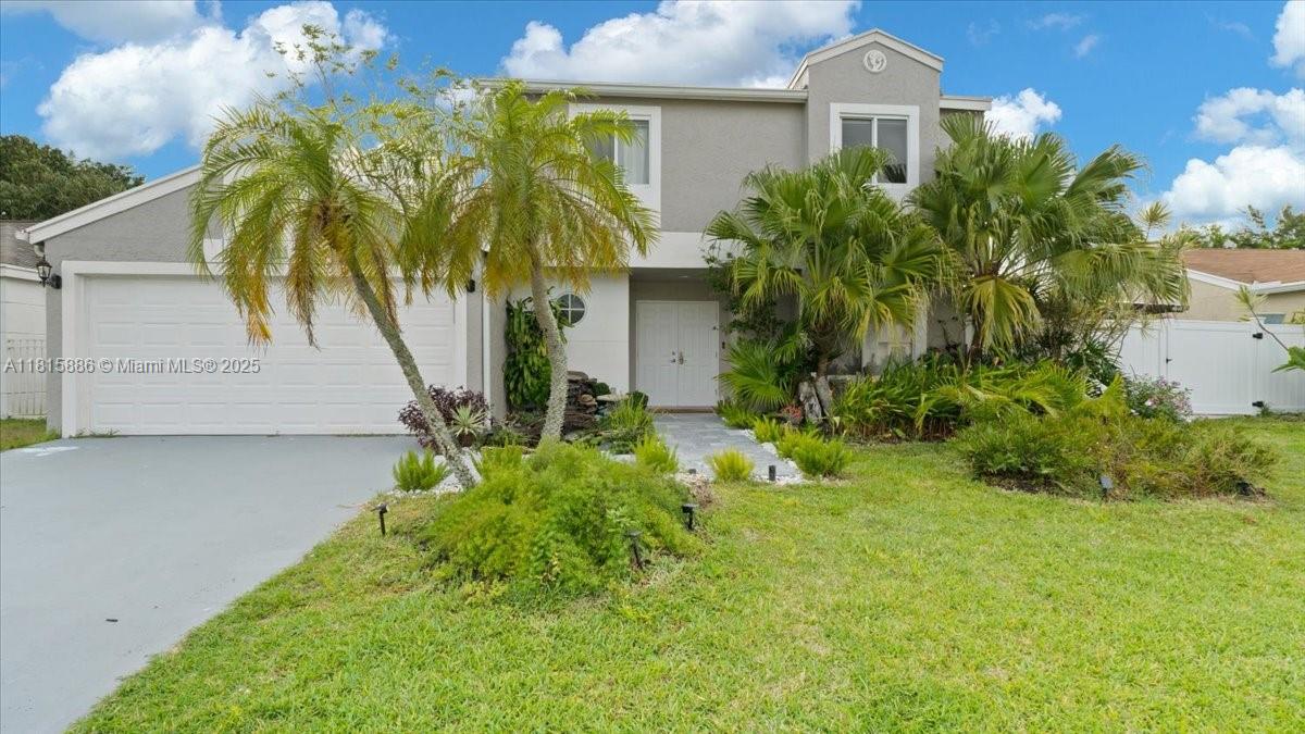 This recently updated single-family home offers 3 bedroom, 2.5 bathrooms, and a spacious office that can be converted into a fourth bedroom. The home features new impact hurricane windows and doors, and a 2-car garage with extra driveway parking. A huge balcony is also connected to a new outdoor kitchen, with a workstation sink, a coal barbecue with a rotisserie grill system, and a bar. Fire pit area, large west-facing completely fenced-in. This private backyard includes mature trees and fruit trees around the entire property. The backyard also includes a charming pergola, waterfall fountain, and one more covered space. Located in Boca Landings, low HOA fee, and residents can enjoy access to community amenities that feature a pool, playground, racquetball, pickleball, and tennis courts .