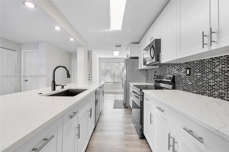 Beautifully Maintained 3-bedroom, 2.5-bath Townhouse (Option for 4th Room In Garage) In The Highly Desirable Townhouses Of Jacaranda Plantation. This Beautiful Updated Townhome Features An Open Layout, & Spacious Living And Dining Areas. An amazing Updated Kitchen With SS Appliances, White Cabinets, And Quartz Counters. The Updated Large Master Suite Has A Walk-In Closet. Ensuite Bath With Updated Vanity. The Second And Third Bedrooms Are Nice Size And Share An Updated Second Bath W/ Lots Of Storage. Enjoy Outdoor Living With A Fenced Back Patio, Balcony And An Open Front Patio. Additional Features Include Accordion/ Hurricane Shutters For Added Peace Of Mind. Conveniently Located Near Major Highways, Dining, And Shopping. Community Has Pool, Tennis, Clubhouse, And Play Area. Must See!