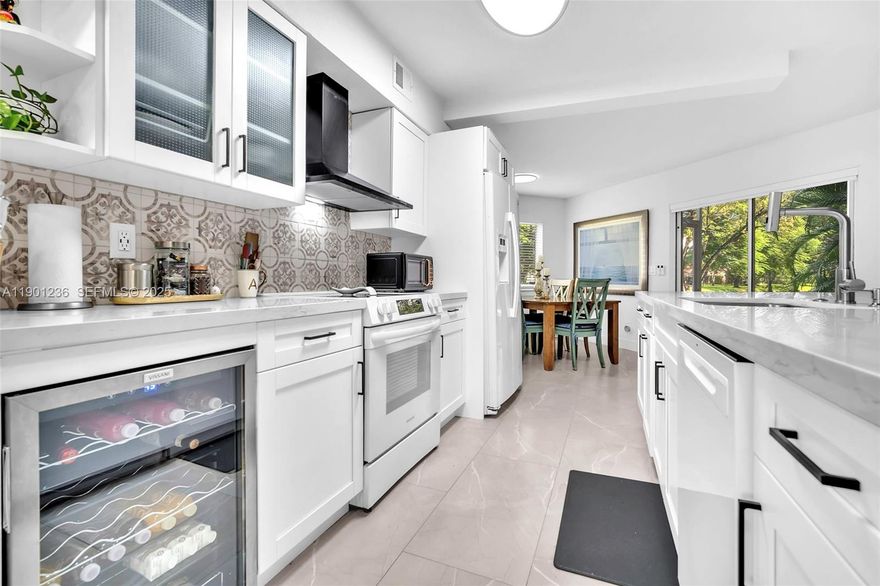 Central Park, Plantation Upgraded two bedroom/two bathroom waterfront property with screened in patio,  one car garage and  storage.  This fully updated property features modern tile floors throughout, recess lighting and an Open-concept kitchen with quartz countertops and designer finishes.  It has light and neutral colors and lots of natural light. The spacious primary suite has a  sitting area and tranquil water views. The screened patio is perfect for relaxing with your morning coffee or evening wine. Exterior/Community: Resort-style pool, spa, on-site maintenance, elegant entry courtyard, and lush landscaping with additional water views. Prime location: close to Plantation Central Park, restaurants, cafés, and shopping