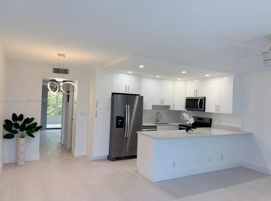 A must see!! Completely Remodeled, Modern and Full of Natural Light. 1 bedroom, 1/1 baths + large Florida room. Upgrades include Open Kitchen with Quartz counter tops, High end Appliances, White Cabinets, Recess Lighting, New Walking Shower, New Water Heater, New Electrical Panel, New Flooring. Located on a 4th floor building with elevator. Gated Active 55+ Community includes Beautiful Amenities, Fitness Center with Classes, Theater, Ballroom, 18 Swimming Pools, Pickleball Cts, Tennis Cts, Gorgeous Miniature Golf, Ping Pong, Bocce, Game Rooms, Restaurant, BBQ Area with Gazebo, Free Shuttle Bus takes you Shopping and Several Restaurants. Lovely community to Live, Relax and Play in Resort Style. Excellent Location!!! Close to various Shops, Restaurants, the Beach, the TriRail that takes you to the Airports and Miami. Priced to Sell!! Just bring your own personal decor. Ideal to live year round or Seasonal.