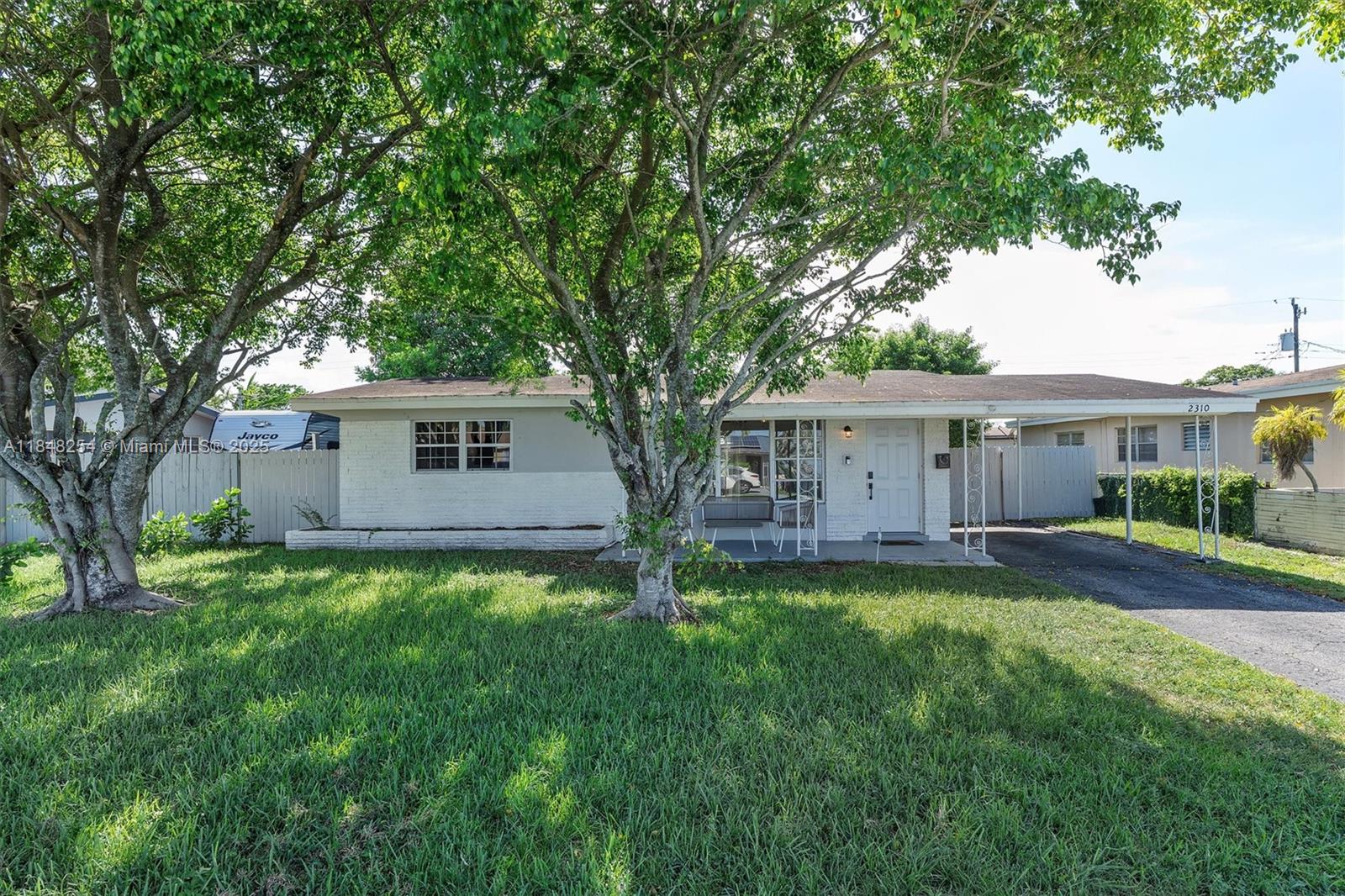 Charming and fully renovated 2-bed, 1-bath home in Miramar, currently operating as a successful vacation rental. Perfect as a primary residence, Florida getaway or income property. No HOA, rent from day one. Features wood-look flooring, open layout, stainless steel appliances, subway tile and open shelving. Full-size washer and dryer in laundry room. Large fenced lot with double gate access, great for toys or a pool. Covered tile patio and carport add comfort and functionality. Minutes from Perry Airport and Hard Rock Stadium. Furniture not included but negotiable.
