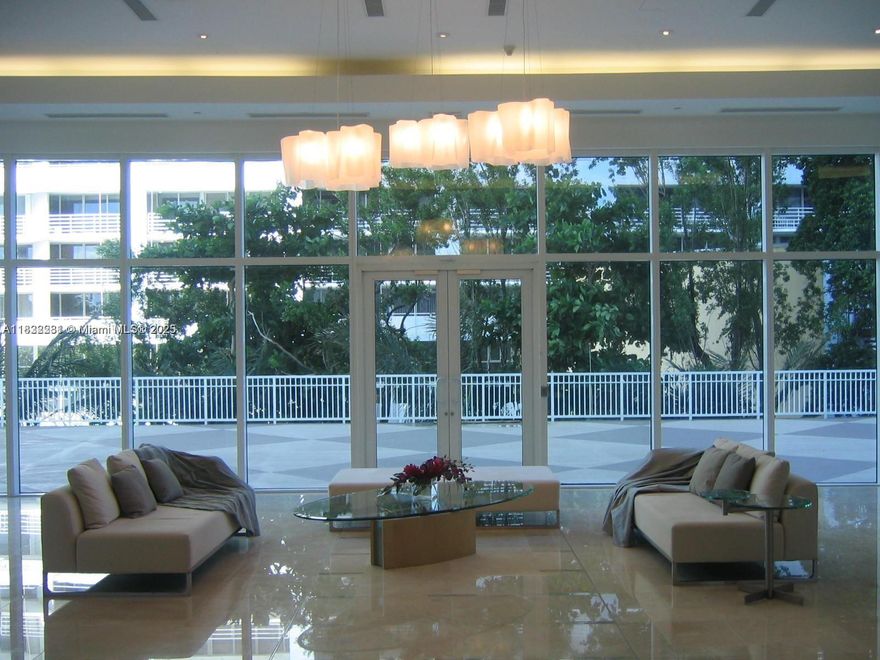 The interior living area is 791 sq. feet plus a 250 sq. ft. balcony with breathtaking views of Biscayne Bay, the Rickenbacker bridge, and the famous "hole" in the Atlantic building next door. The apartment has northern exposure, giving you gorgeous sunrises in the morning, but never direct sun. Just happy light with no baking heat. The floors are cream-colored marble, with the lightest of blue-grey walls.