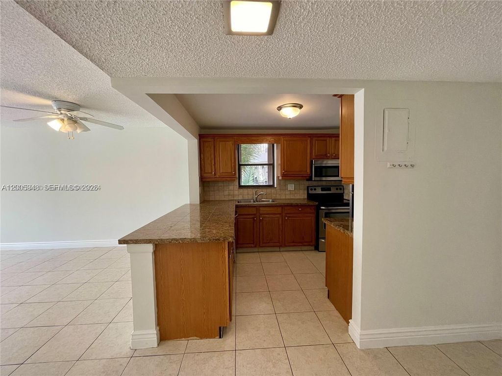 Photo of 2320 S Cypress Bend Dr #204, Pompano Beach, FL 33069 (MLS # A12005948)