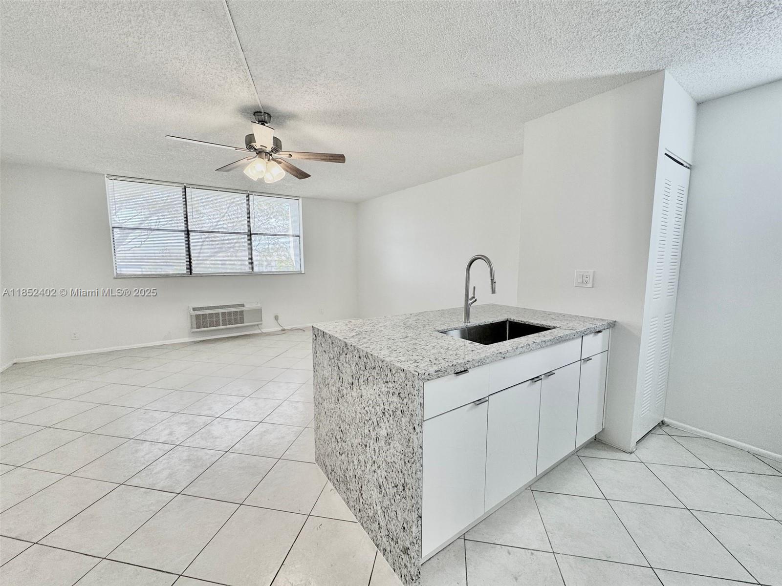 ONLY 1ST MONTH & SECURITY DEPOSIT - Beautiful Move-In Ready Studio in the Heart of Coral Springs! Don’t miss this beautifully updated studio apartment featuring brand new kitchen cabinets, sleek granite countertops, stainless steel appliances, and elegant tile flooring throughout. The spacious walk-in closet offers ample storage, and the rent includes water, trash, and one assigned parking space. The building provides secure entry and fantastic community amenities such as a sparkling swimming pool and a relaxing hot tub. Conveniently located close to major highways, public transportation, shopping, dining, and everything Coral Springs has to offer. Stylish, affordable, and centrally located — this gem won’t last! Fast association approval – schedule your tour today!