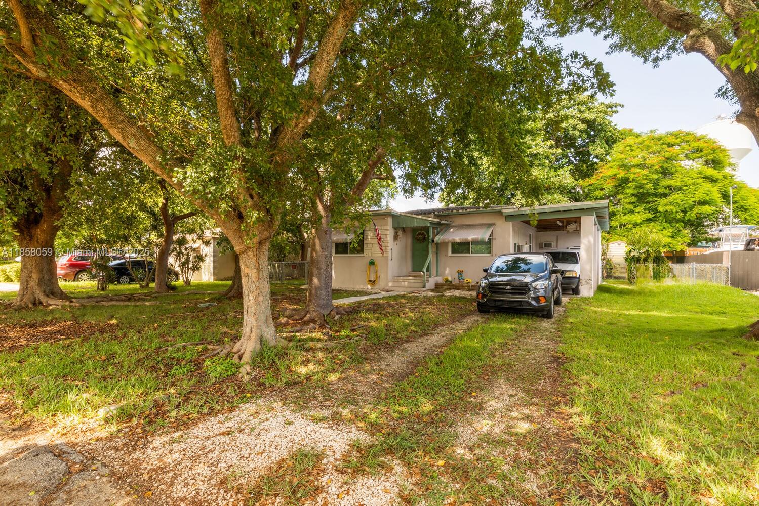 GREAT STARTER HOME , READY TO MOVE IN ... 1952 SOLID BUILT HOME , WITH HUGE FENCED BACKYARD , MATURE TREES , AND PLENTY OF ROOM TO PARK YOUR BOAT AND TOYS. ROOF IS 10 YEARS OLD , HOME IS INSURABLE FOR FINANCING , WITH IMPACT WINDOWS AND AWNINGS . WELL MAINTAINED HOME WAS TENTED IN APRIL 2025 . ENJOY THE HUGE MASTER BEDROOM, BEAUTIFUL REMODELED BATHROOM AND UPDATED KITCHEN WITH WOOD LAMINATE FLOORS . STOP PAYING RENT , COME AND ADD YOUR PERSONAL TOUCH TO THIS CHARMING HOME AND MAKE IT YOURS ...CARPORT COULD BE ENCLOSED AS A SCREEN ROOM OR FAMILY ROOM OR EXTRA BEDROOM FOR MORE LIVING SPACE. NO CDD , NO HOA