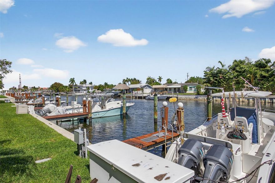 Discover Nobel Point — an intimate, gated, waterfront community with its own assigned private boat dock in east Pompano Beach just west of the Intracoastal. Pet Friendly. This move-in ready split-plan 2-bedroom, 2-bath condo includes  and offers easy boating access to the Hillsboro Inlet in about 15–20 minutes. Inside, enjoy an updated kitchen with white cabinetry, a generous center island, stainless steel appliances, and updated bathrooms. Unwind on the spacious, screened balcony (approx. 26' long) and watch the waterway activity. Community perks include a pool with hot tub, tennis/pickleball courts, fitness center, and a tiki/BBQ area. Two parking spaces (one covered) are included. Live every day like a getaway—don’t miss this one.