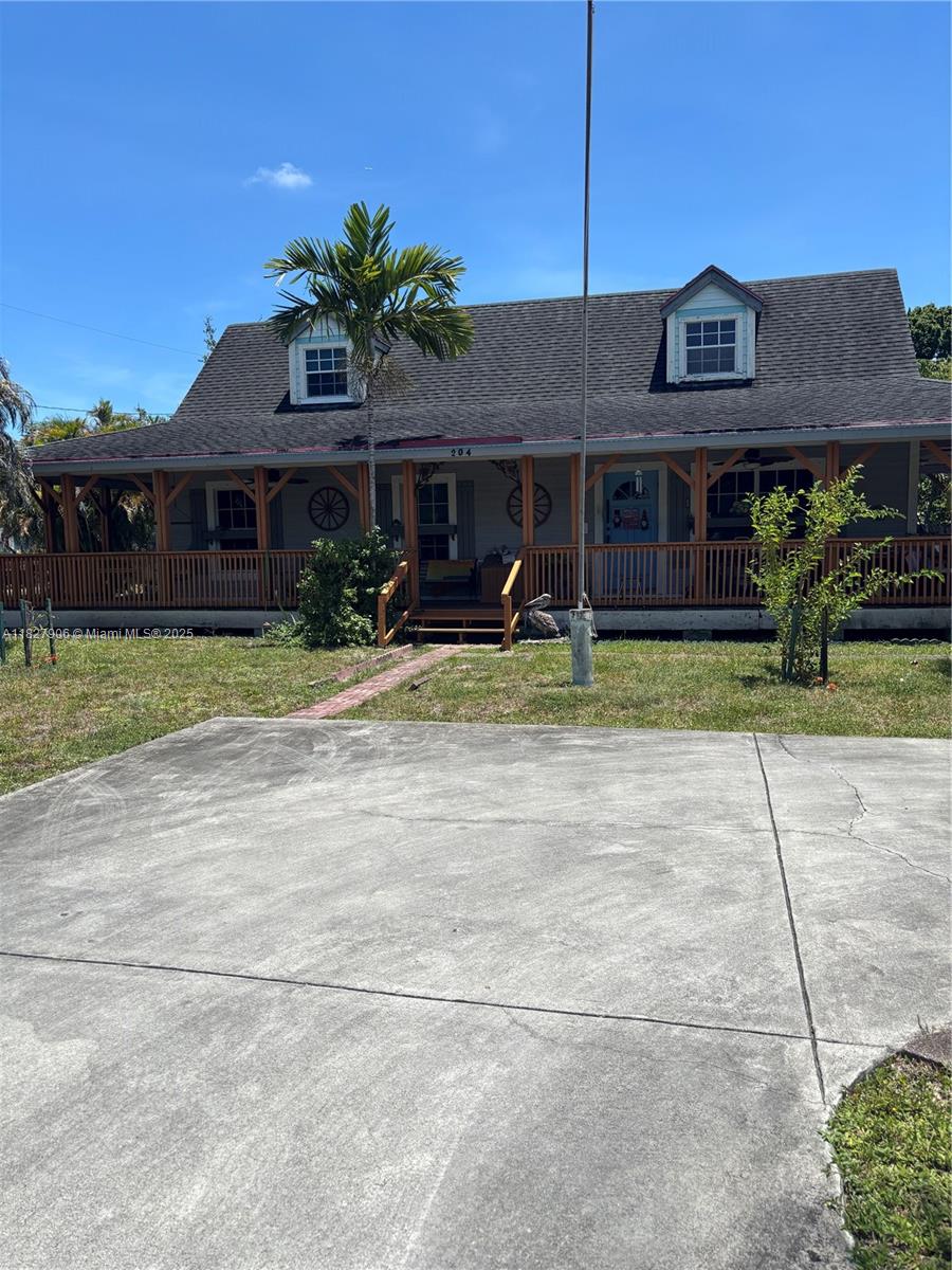 Charming Key West Style Oasis on Expansive Corner Lot! Discover your slice of paradise in this one-of-a-kind, 3-bedroom, 2-bathroom Key West style home, perfectly situated on a generous corner lot. This unique property exudes coastal charm from the moment you arrive, highlighted by its inviting wrap-around porch – ideal for enjoying morning coffee or evening breezes. Step inside to find a warm and character-filled interior featuring stunning exposed wood ceilings that add to the home's distinctive appeal. Each space is thoughtfully designed to offer comfort and style. Beyond the main residence, a detached 3-car garage provides ample space for vehicles, storage, or even a workshop, offering incredible flexibility.