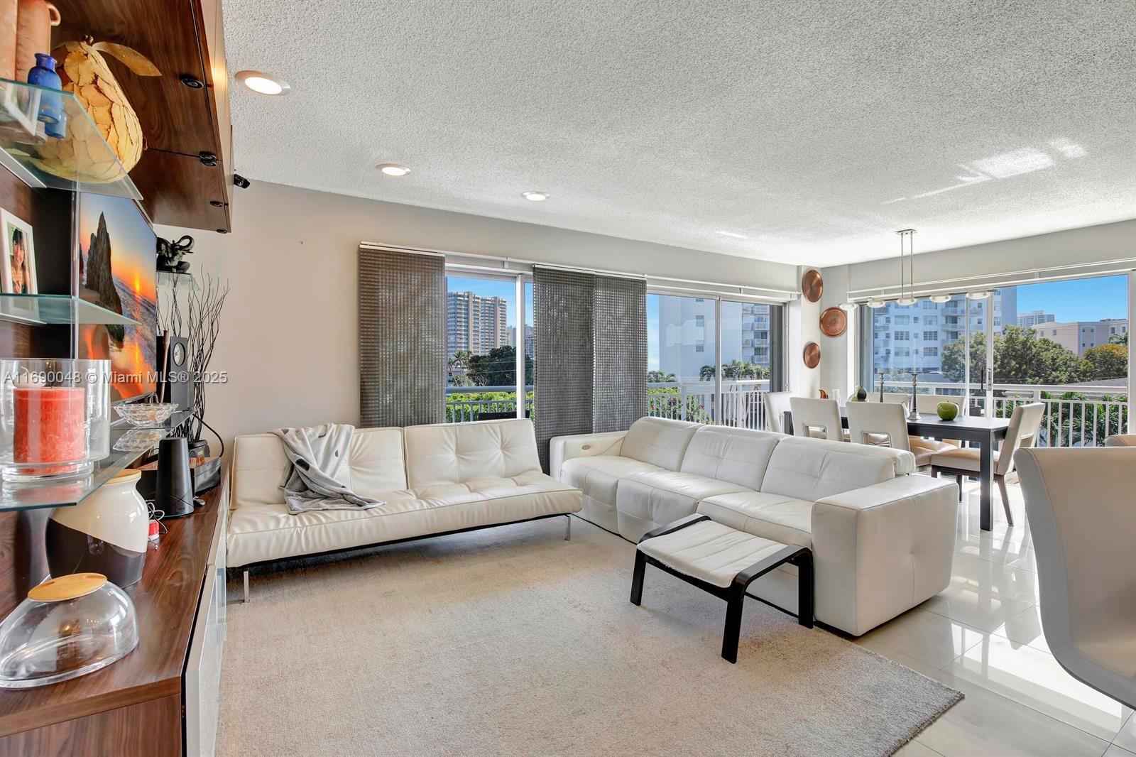This stunningly updated waterfront corner unit is located in an exclusive boutique-style building with just four units per floor. Enjoy northwest exposure and a wrap-around balcony with partial Intracoastal water views. The bright and spacious interior features two bedrooms, two baths, and a sleek modern design. The kitchen shines with granite countertops, wood cabinets, stainless steel appliances, and a convenient sit-down bar area. Impact windows and shutters provide added security. Community amenities include a heated pool, BBQ area, one covered parking space plus an additional uncovered spot, and two storage units. Complimentary laundry facilities are available on each floor, ensuring ultimate convenience. Ocean access completes this remarkable offering! Current waitlist for dockage.